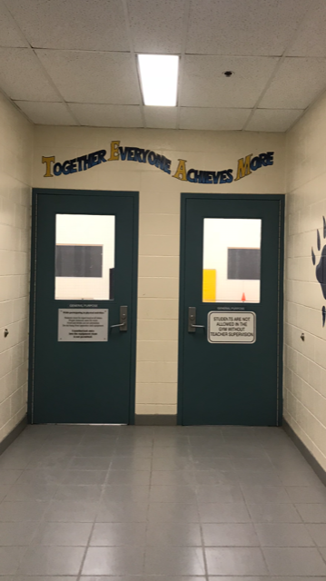 Picture of a school hallway with two doors